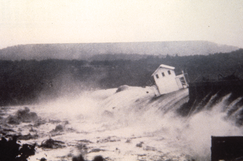 Floodwaters carry a two-story home over Austin Dam, 1935